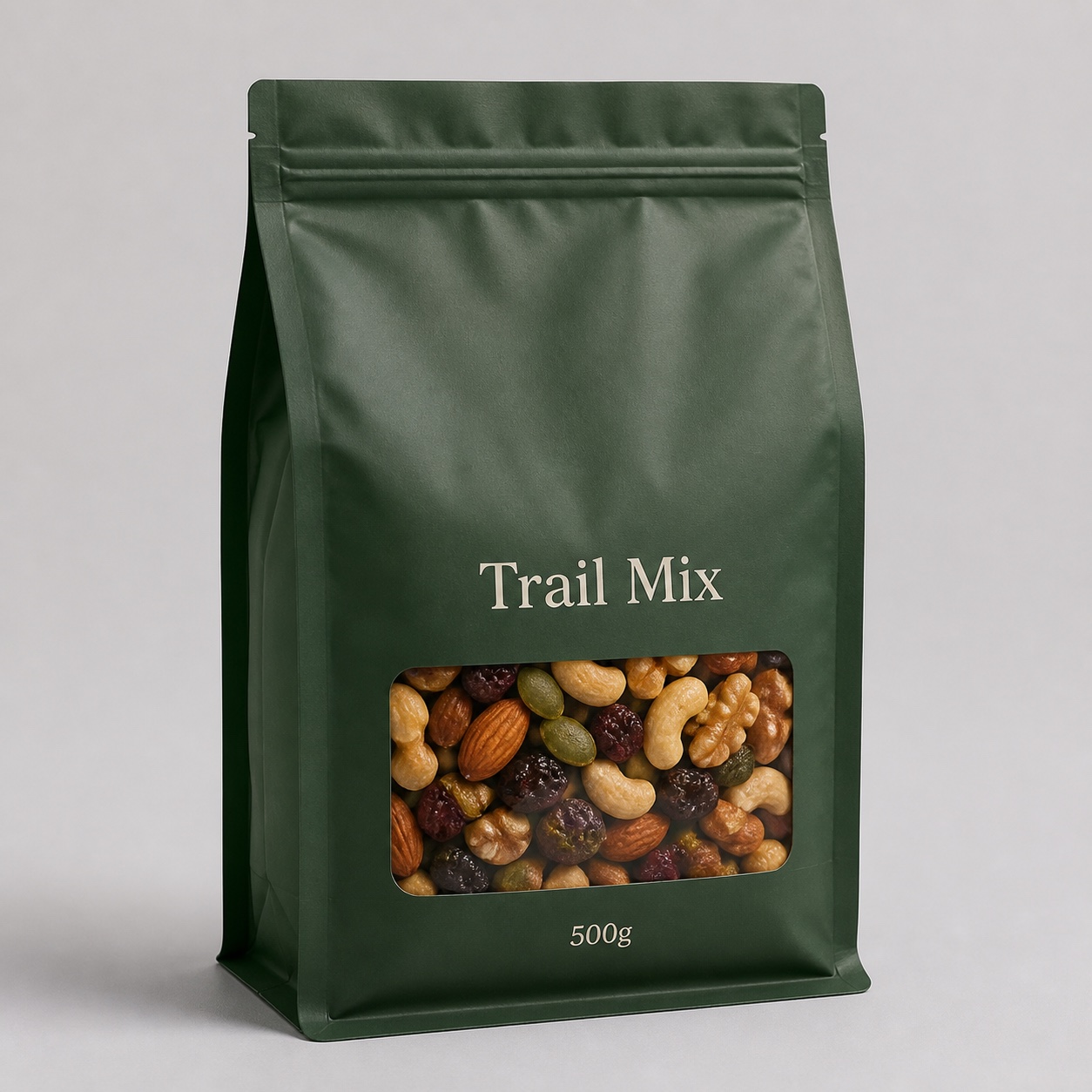 Green flat bottom trail mix pouch with front window, broad base, zipper track, and generic trail mix text
