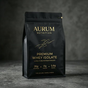 Matte black quad seal protein powder bag with gold lettering on a dark stone surface