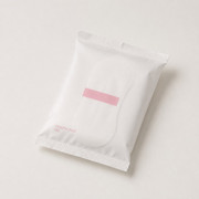 White single hygiene liner wrapper with crimped ends and a pink tab