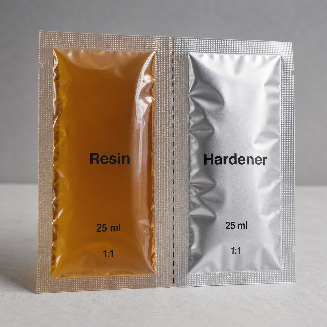 Connected twin resin and hardener pouch with center perforation